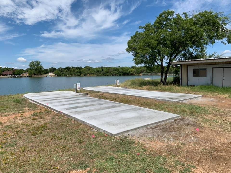 Two reinforced concrete slabs poured on a lakeside property near a boat dock